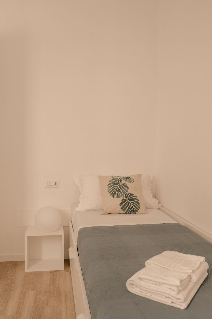Single bed of a small room inside Pirouette, the holiday home with garden in Alassio. 